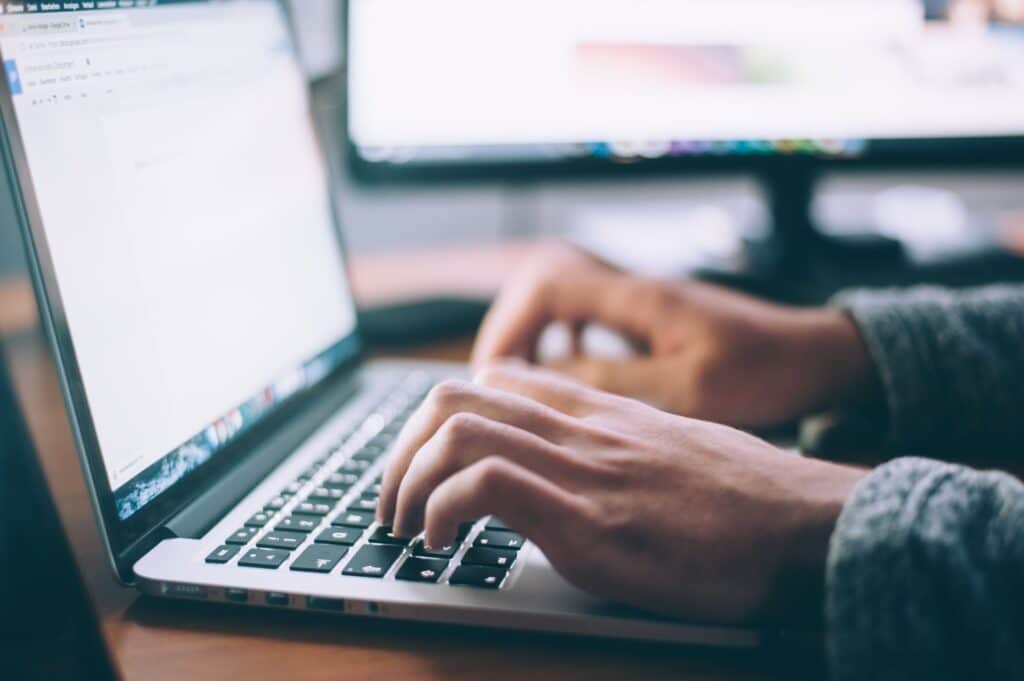 image of person working on computer with excel files