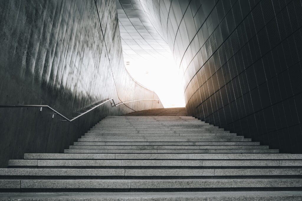 a tall stone staircase. Nothing can be seen at the top of the stairs